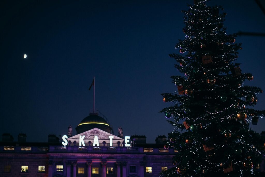 A festive scene in London showcasing Christmas lights, holiday decorations, and people enjoying the winter season on a budget