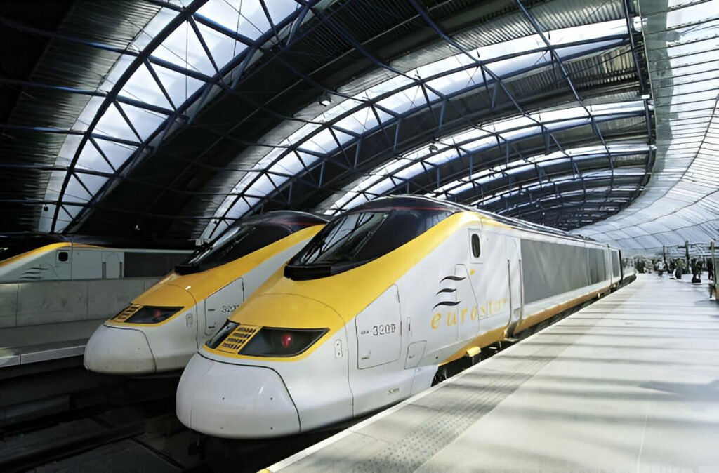 Two Eurostar trains passing through scenic landscapes in Europe