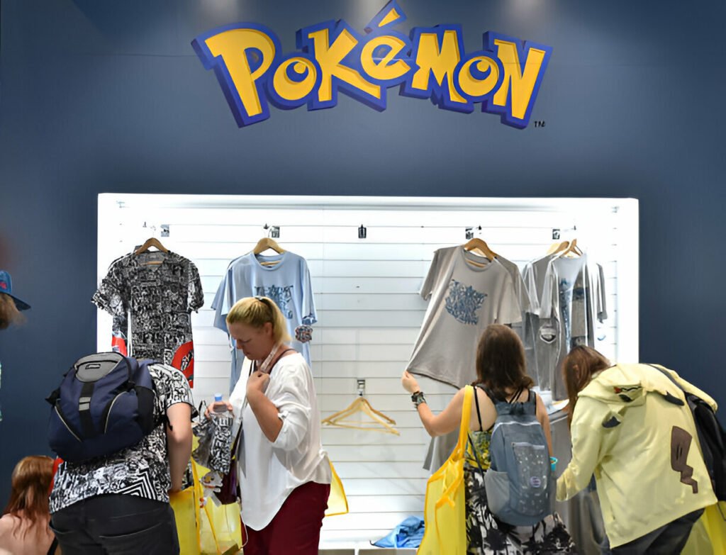 People shopping exclusive Pokémon merchandise at the Pokémon Center London 2025, including clothing and collectibles