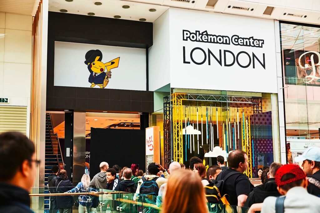 People walking into the Pokémon Center London 2025,, excited to explore exclusive Pokémon merchandise and experiences.