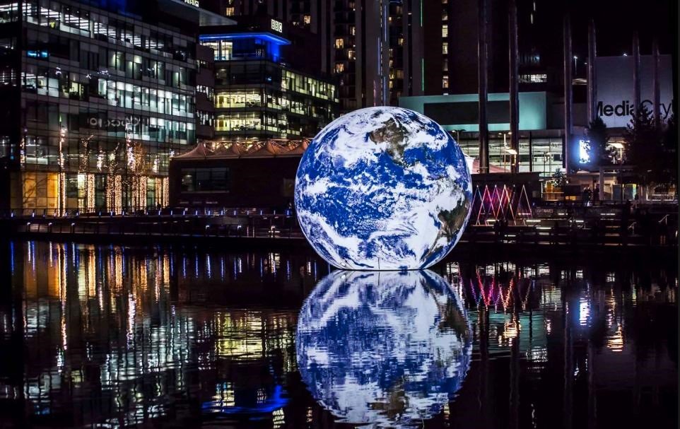 Canary Wharf Winter Lights 2025 Festival featuring a glowing lighting ball installation over the water