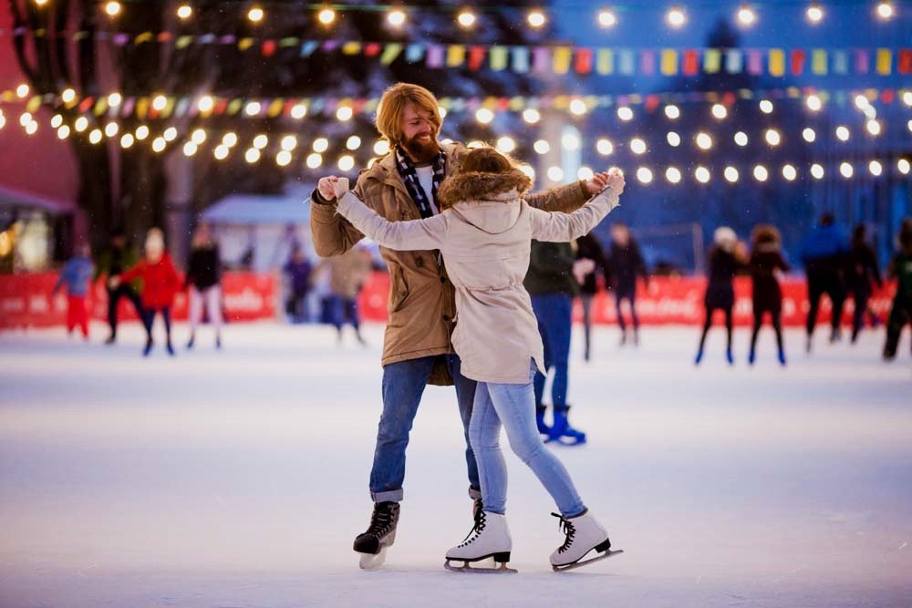 Couple ice skating at Canary Wharf Winter Lights 2025 ice rink