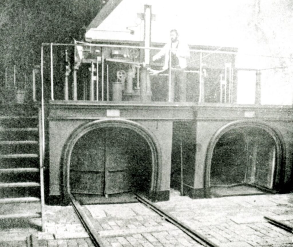 An underground railway tunnel with vintage mail carts used for postal delivery