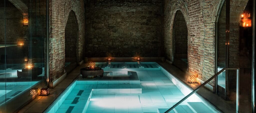 Candle-lit underground thermal pools at AIRE Ancient Baths London