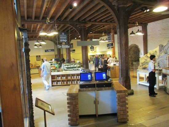 A cozy café inside the Tower of London with a view of the historic fortress and River Thames.