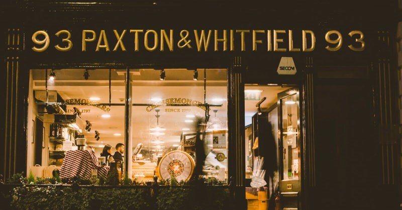 A historic cheese shop with shelves full of artisanal cheeses