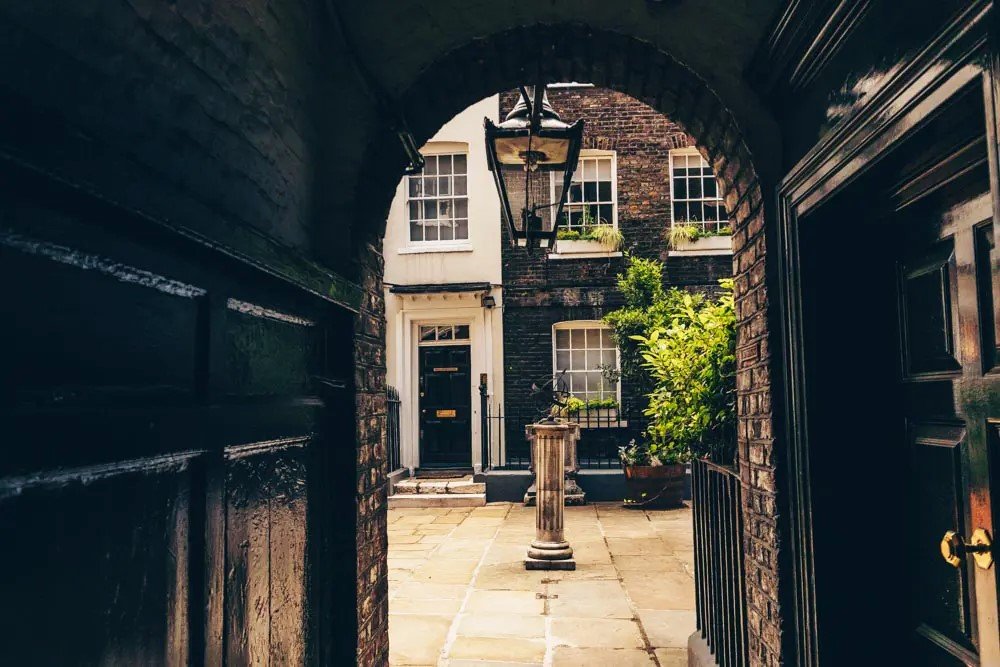 A tiny cobbled square hidden between historic buildings in London