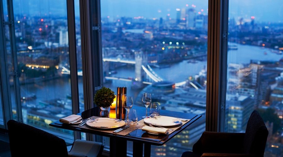 A luxurious dining setting at TĪNG Restaurant in The Shard, showcasing stunning views of London’s skyline