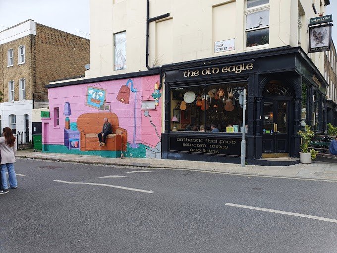 A colorful Simpsons-themed mural on the exterior wall of The Old Eagle Pub in Camden