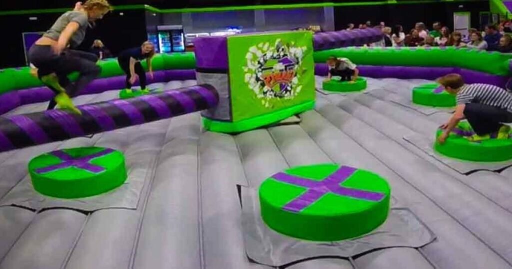 Try to stay standing in the thrilling Wipe Out challenge. Rotating beam challenge on a trampoline platform