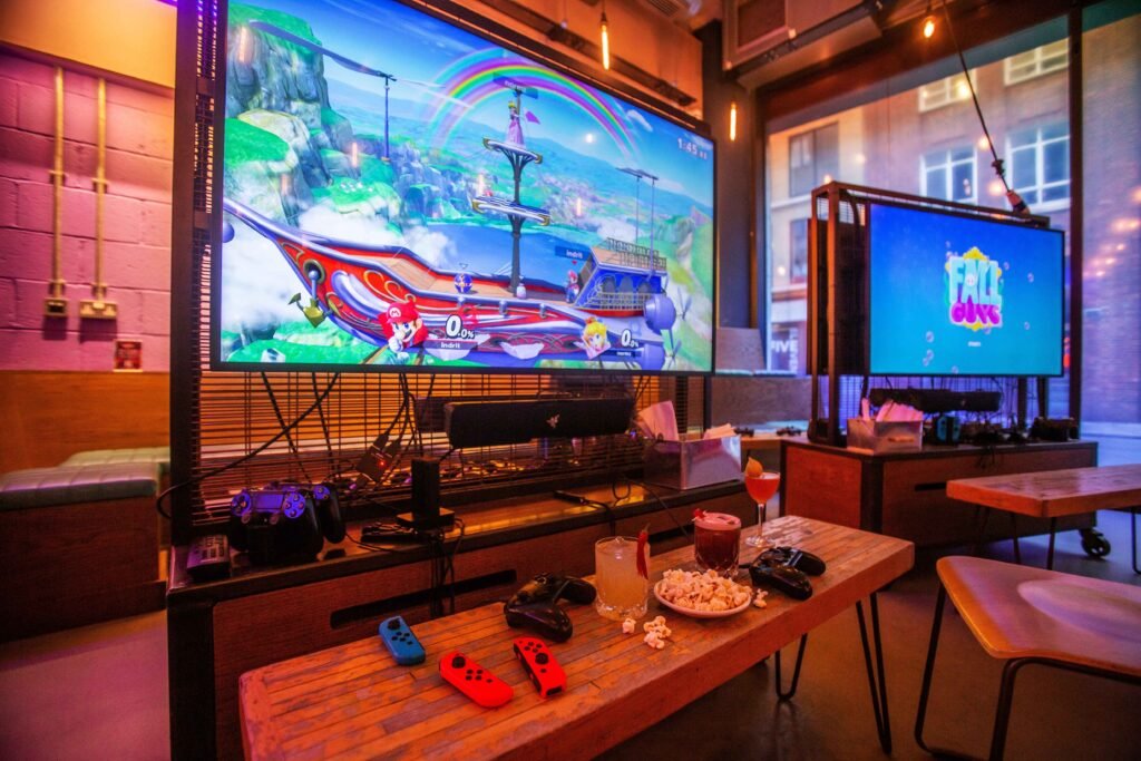 Platform Shoreditch gaming bar in London with gaming booths, esports stage, and vibrant atmosphere